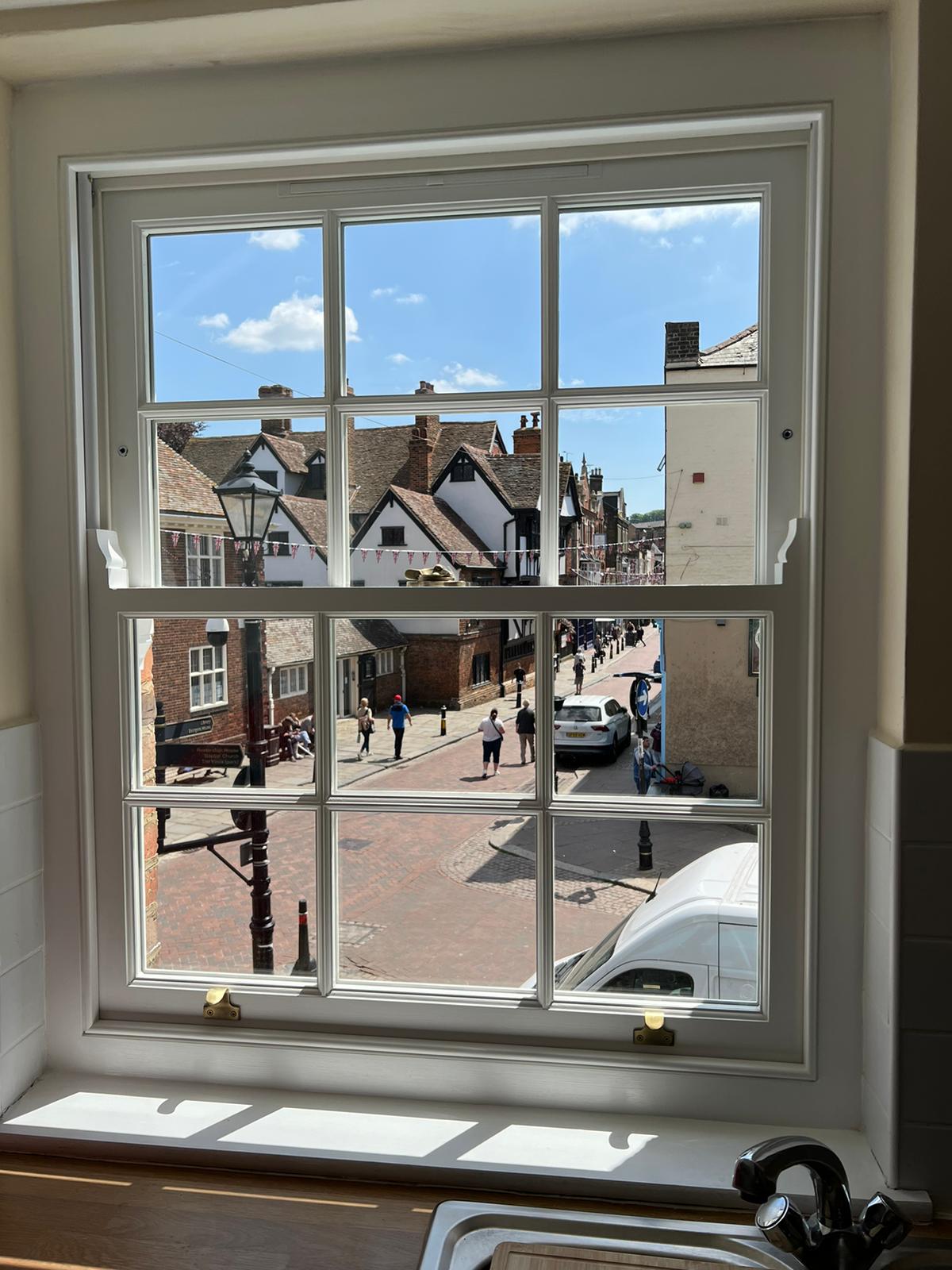 Sash window showing people out in the street