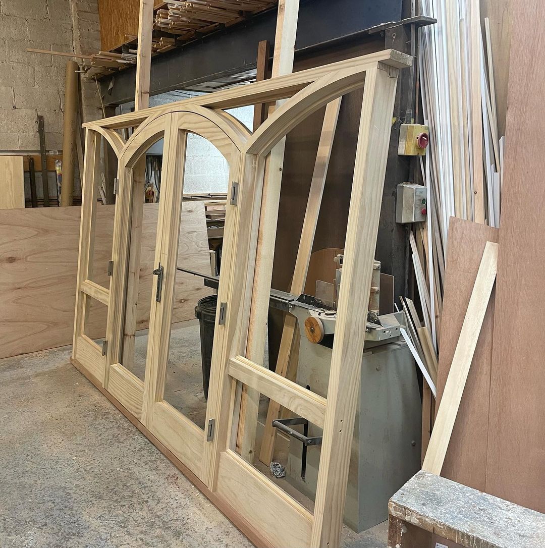 Pair of shaped Accoya Doors and frame awaiting painting and glazing