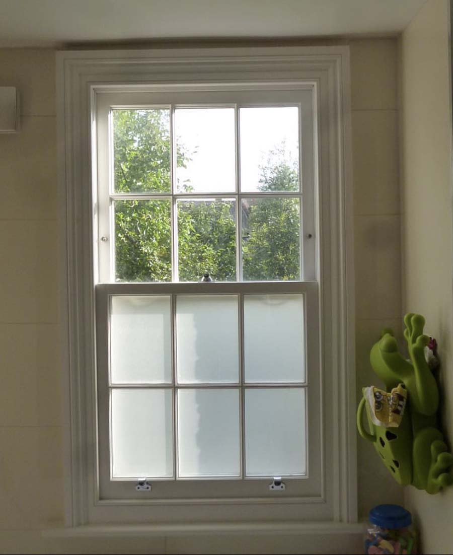 Sash window with privacy film in London