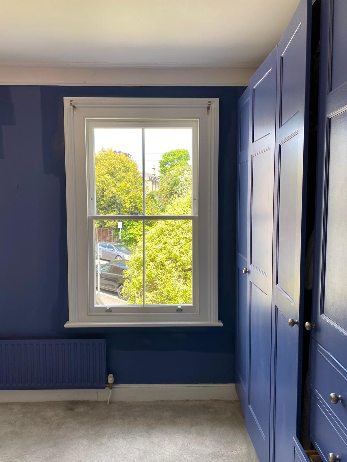 Casement window fitted in a blue room